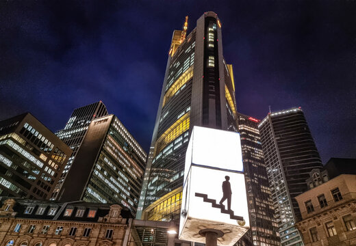 Frankfurt financial district skyscrapers illuminating city night with Commerzbank Tower