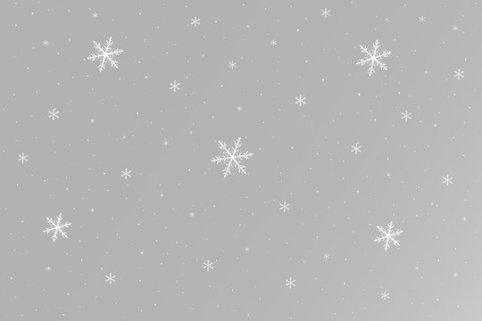 Snow with delicate white snowflakes falling at different sizes creating a beautiful winter decoration effect