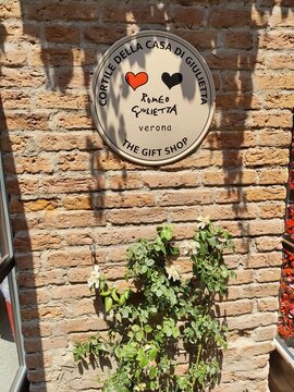 Casa di Romeo and Giulietta Juliet's House Gift Shop Sign in Verona Italy on old Brick Wall. Verona, Italy - June 25, 2026