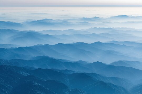 The Expansive Blue Mountain Range Layered in Misty Atmospheric Light