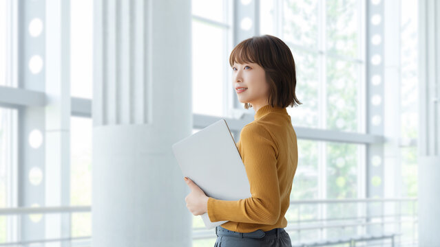 ノートパソコンを持つ女性・ビジネスウーマン, Businesswoman Holding a Laptop Computer