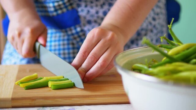 Hands Grabbing and Lining Up Fresh Green Beans for Chopping in Home Kitchen