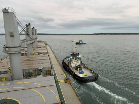 tug boat approach ship for assistance. mooring operation.