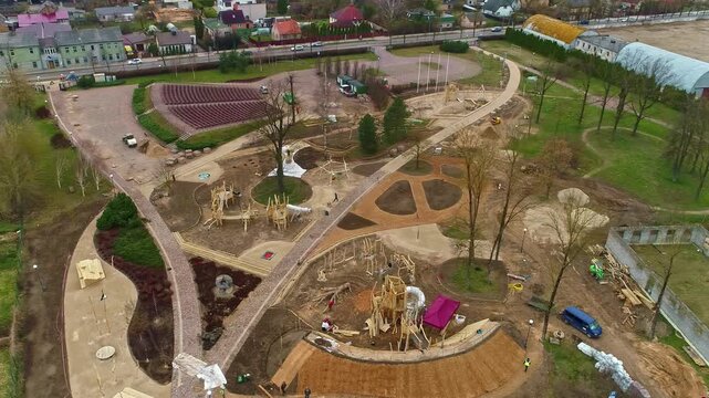 Latvia - 09 October 2023: Aerial view of a park under construction featuring winding pathways, wooden play structures, and ongoing landscaping work.