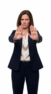 A medium-shot video based on the provided character, showing a serious professional woman in a dark blue pantsuit and cream blouse. The video starts with her looking directly at t