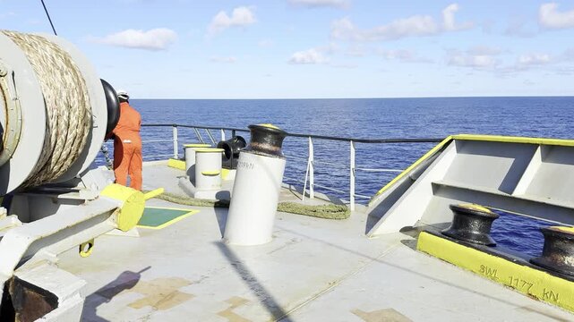 Professional mariners handling thick ropes for upcoming port arrival. ship proceeding at ocean.