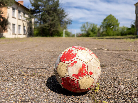 Old Soccer Ball on Abandoned School Playground Court with Goalpost, Nostalgic Childhood Memory