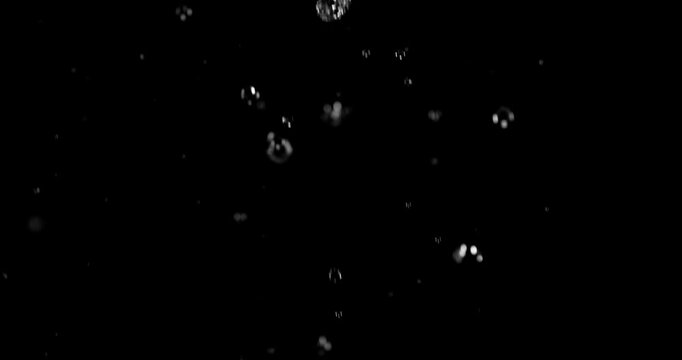 Ultra slow motion falling water droplets isolated on a black background creating a realistic rain VFX overlay. Perfect for cinematic compositing visual effects and motion graphic.