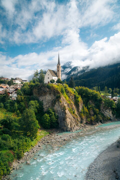 Scuol church with Inn river in summer, Scuol, Engadin valley, Graub&uuml;nden, Switzerland