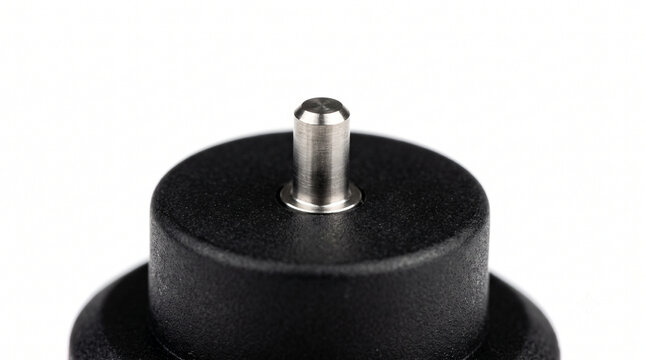 Extreme macro of a dive computer water contact pin. Micro-machined titanium electrode in dense black resin base.