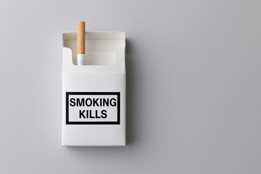The Cigarette Pack with Bold Warning Label in Minimal White Studio Setting