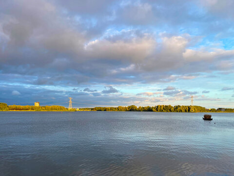 The modern city of Almere in a bright blue cloudy sky, at sunset  Almere, Flevoland, the Netherlands, July, 2026