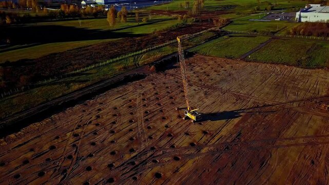 Latvia - 18 February 2023: Aerial view of a construction site with a piling rig drilling holes in the ground.