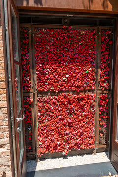 Door Wall of Red Love Padlocks in Verona with Romantic Names and Dates Written on Padlock in Juliet's courtyard. Verona, Italy