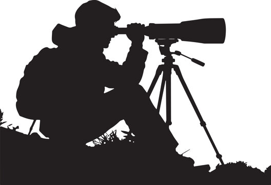 Black silhouette of a person sitting on a hill looking through a spotting scope