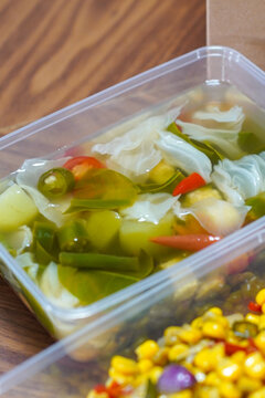Close up of Indonesian sayur asem, vegetable soup with cabbage, corn, chili and herbs in light broth. Healthy traditional Southeast Asian cuisine.