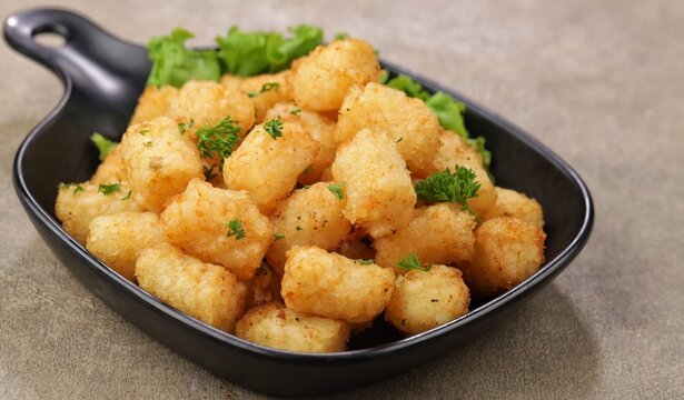 Delicious fried potatoes known as tater tots or pom pom potato