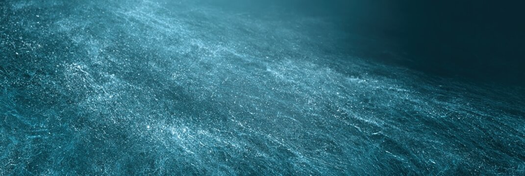 Abstract shimmering turquoise water surface with flowing light streaks and particles, deep ocean background