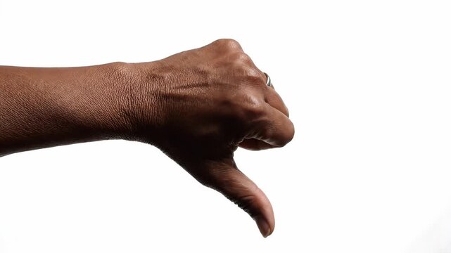 Close up of a human hand making a thumbs down sign representing failure or rejection