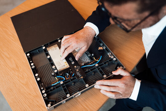 Engineer repairing electronic hardware component in the office