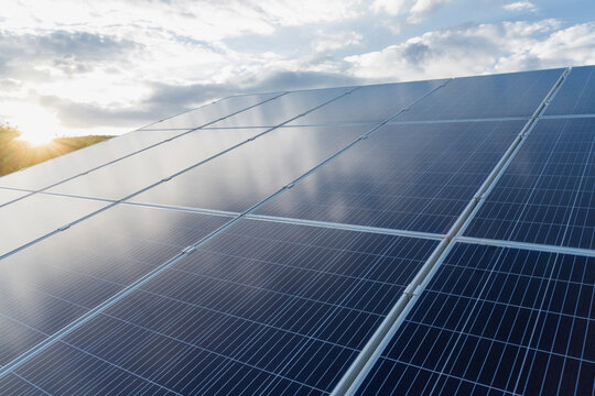 Solar panels in front of cloudy sky