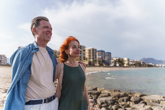 Senior couple enjoys a beach vacation by the ocean