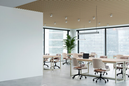 Modern open office interior features empty workspace and copy space