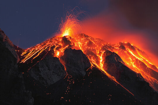 Eruption of Stromboli volcano with lava flow at night in Sicily