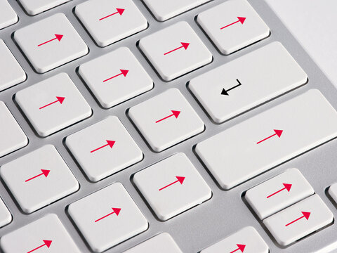 Computer keyboard keys showing arrows pointing opposite directions. Going against the flow, resistance, opposition, nonconformity and challenge concepts.