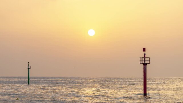 sun rising over the horizon on a hazy morning in barcelona