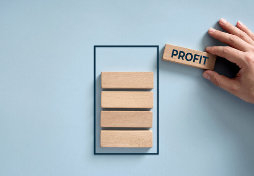 Hand adding profit block, building business success strategy