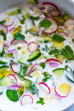 Cold cucumber soup with kefir and yogurt, summer light salad with mint, eggs, onion and herbs. Traditional Greek and Balkan cuisine, Tarator, Tzatziki. Healthy, vegetarian, diet, low calorie