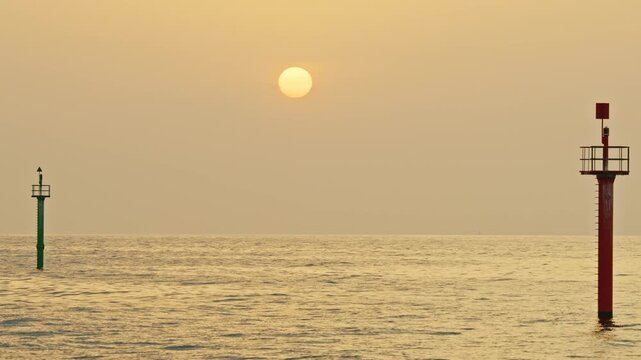 sun rising over the horizon on a hazy morning in barcelona