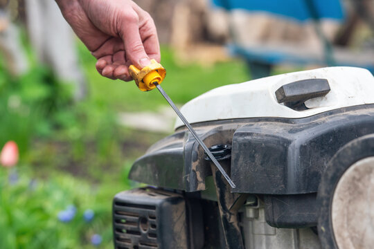 Checking the oil level in the cultivator with a dipstick