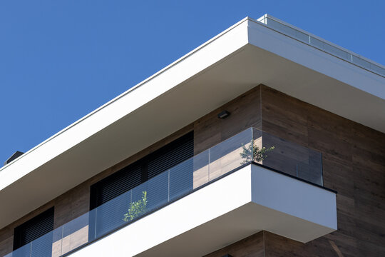 modern apartment building corner detail with glass balcony