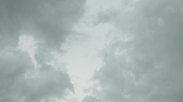 A low-angle shot of dark, heavy storm clouds gathering in a gloomy sky before a rain.