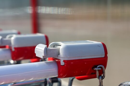 Shopping cart handle with coin lock mechanism showing retail
