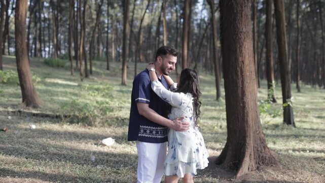 Romantic Couple Walking Together in a Serene Pine Forest During Daylight