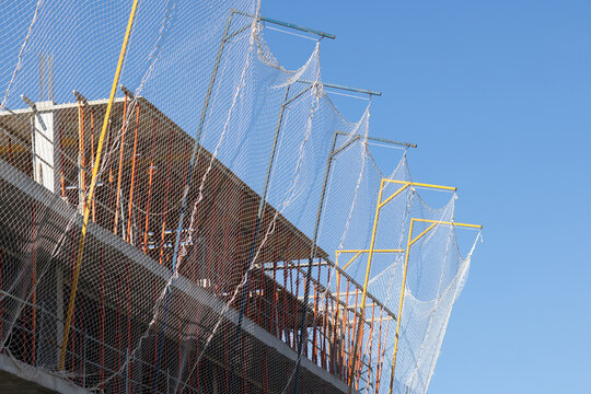 safety net system installed on a building under construction against a blue sky. copy space