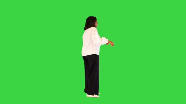 Inspired african american female soul singer dances slightly snapping fingers on a Green Screen, Chroma Key.