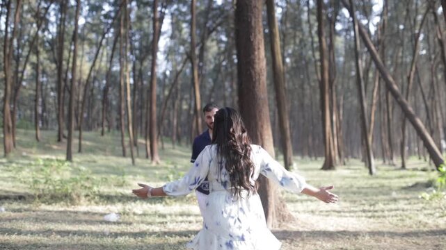 Romantic Couple Walking Together in a Serene Pine Forest During Daylight