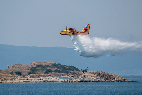 Fire fighter airplane during training throws water on small island.