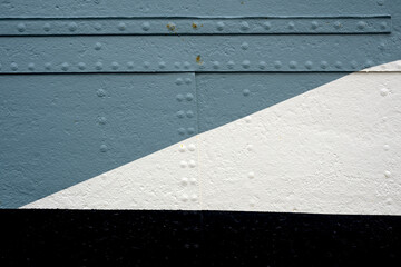 Fototapeta premium Weathered painted metal panels in blue grey and white form a diagonal geometric composition