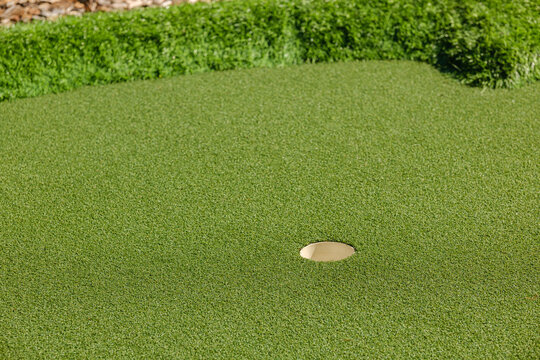 Golf hole on a green putting surface