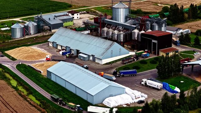 Riga, Latvia - 26 August 2025: Aerial view of grain processing facility with silos and trucks.