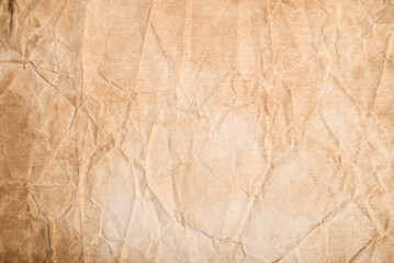 Fototapeta premium Old paper texture. Aged crumpled paper with natural wrinkles, creases and a weathered vintage surface.