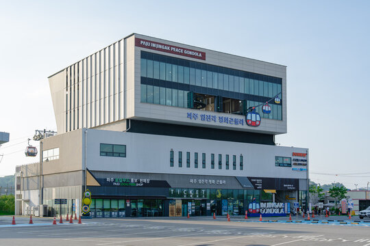 July 12, 2026, Paju, South Korea - Paju Imjingak Peace Gondola building with gondola cabins, a local food shop, and a Dunkin' store