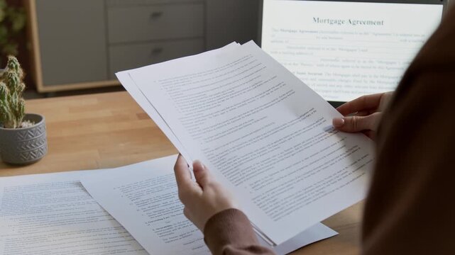 Woman Leafing Through Mortgage Agreement Documents Close Up 4K