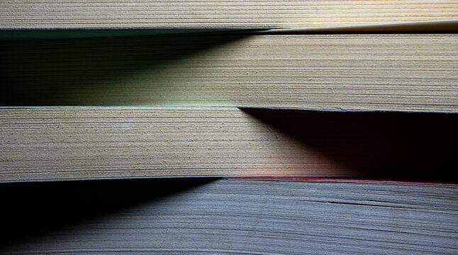 Stacks of aged books presenting paper texture