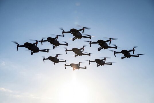 Drone swarm formation flying together in sky technology aerial view